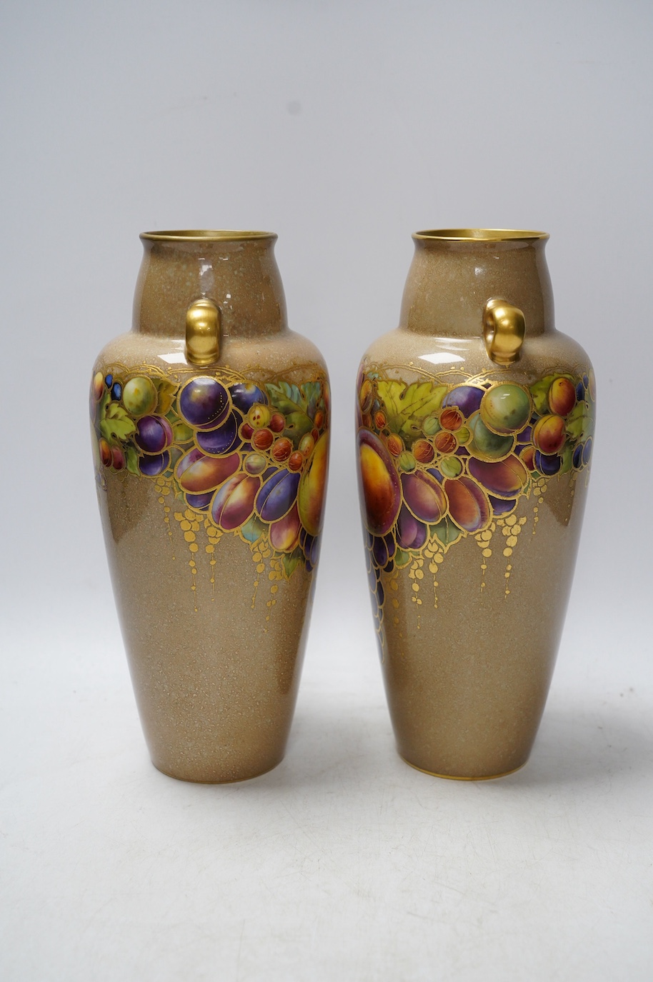 A pair of Worcester vases, decorated with fruit and berries, model number 2768, 26cm. Condition - good